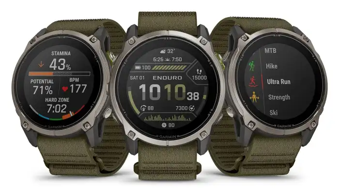 Garmin Enduro 4 titanium sports watch with a dark olive ComfortFit fabric band in five views, showing the watch face, stamina data and sport profiles