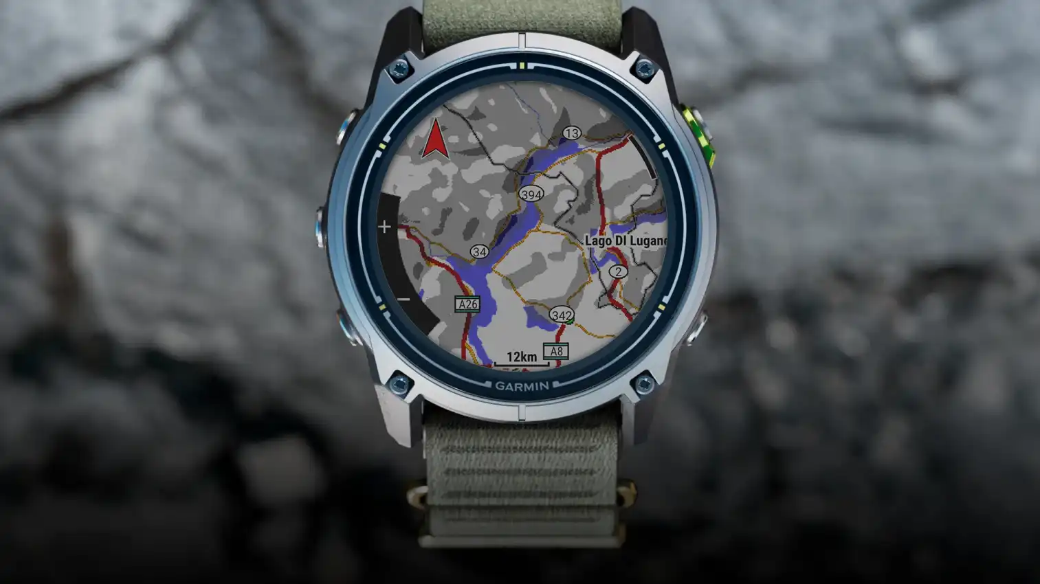 alt="Garmin Enduro 4 titanium sports watch with an olive fabric band, displaying a map of the Lake Lugano area