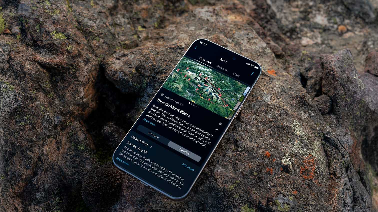 Smartphone resting on a rock, displaying a Tour du Mont Blanc route map and travel journal